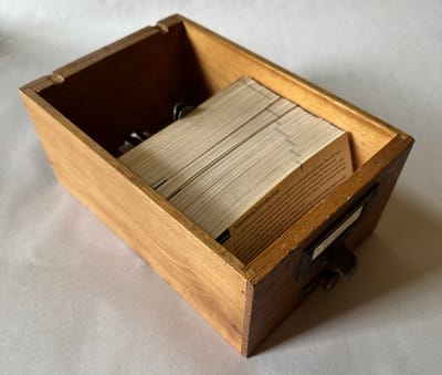 A salvaged card catalog drawer containing hundreds of 3x5 cards contaiing an architecture senior thesis from 1995.